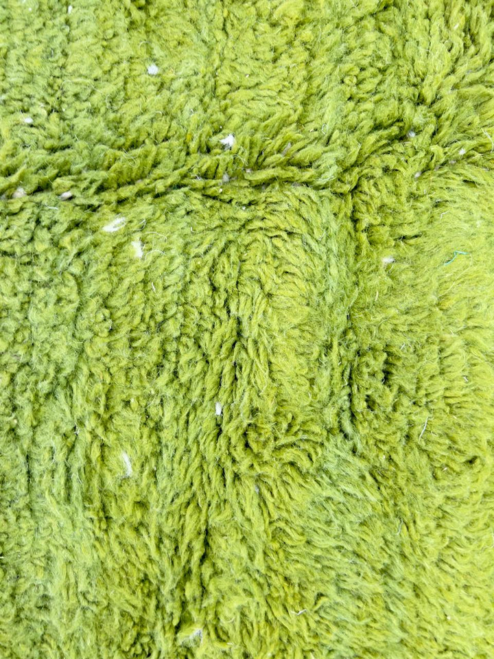 Round abstract Moroccan rug with vibrant green and white organic pattern.