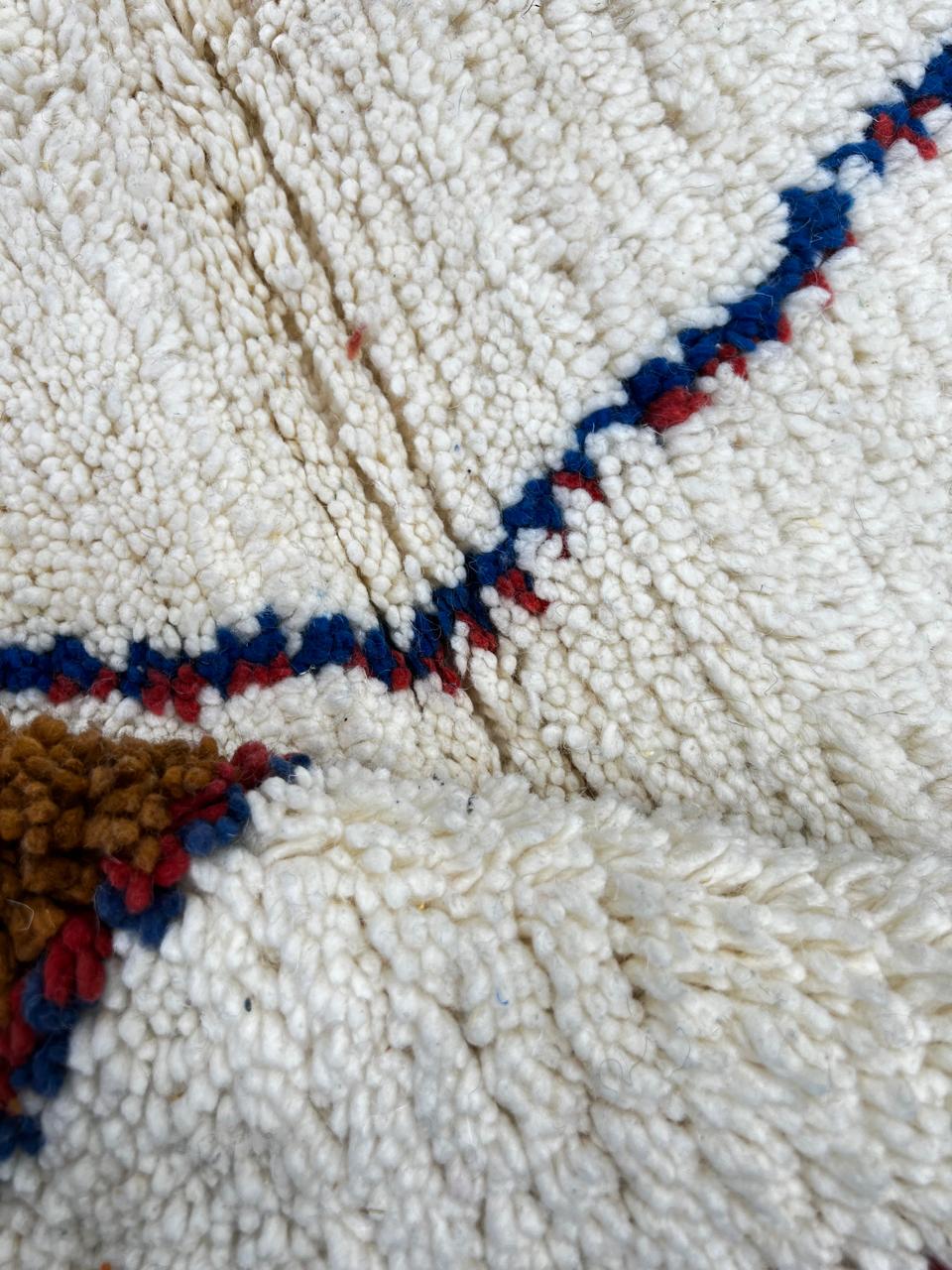 Abstract handmade Moroccan wool rug in green, red, blue, brown, and cream – geometric Berber design
