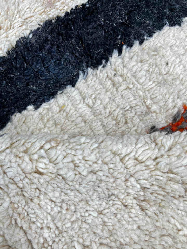 Handmade ivory Moroccan wool rug with orange, black, yellow, and gray abstract stripe patterns – modern Berber rug
