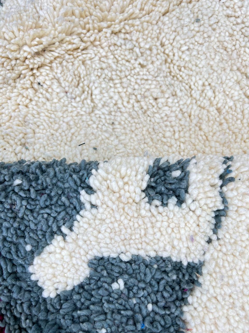 Handmade Moroccan wool rug with abstract Berber-inspired design, earthy tones, and round shape.