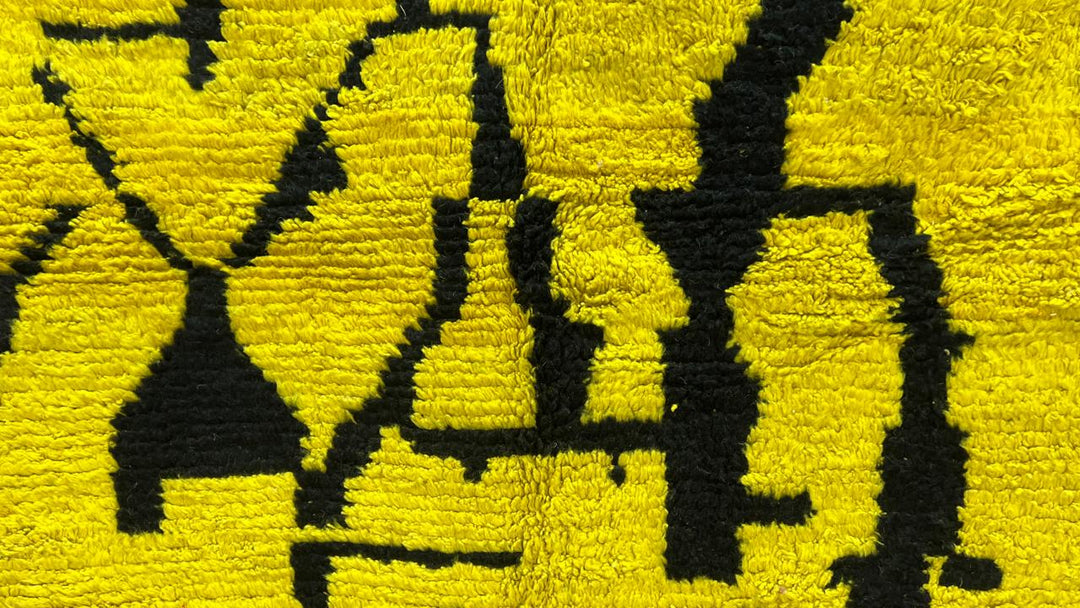 Yellow Moroccan wool rug with abstract Berber design and black line pattern