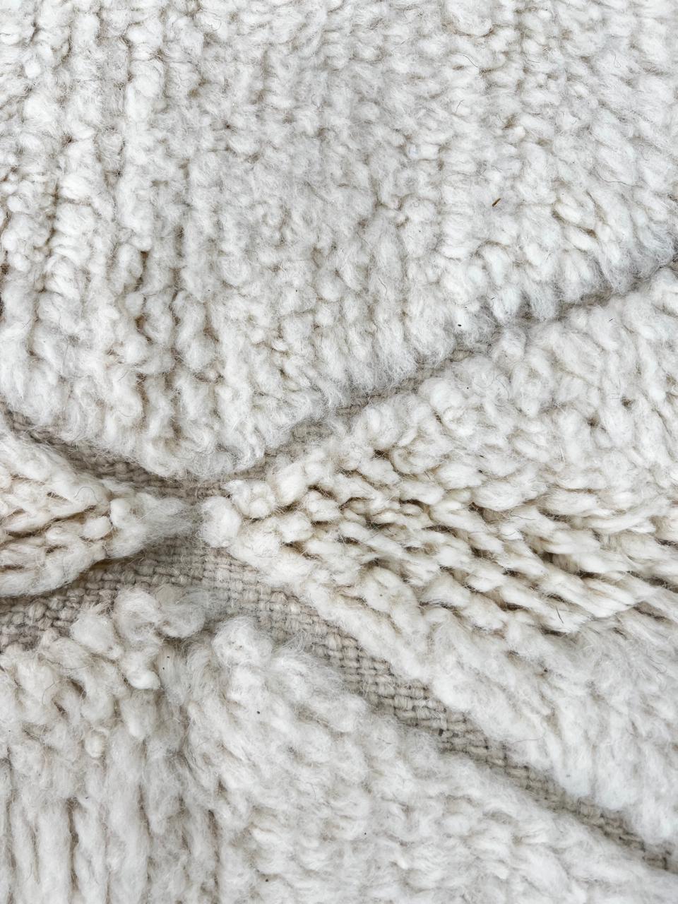 Beige Beni Ourain Moroccan wool rug with chevron line pattern and handmade Berber craftsmanship
