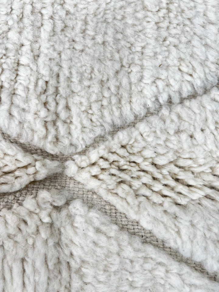 Beige Beni Ourain Moroccan wool rug with chevron line pattern and handmade Berber craftsmanship