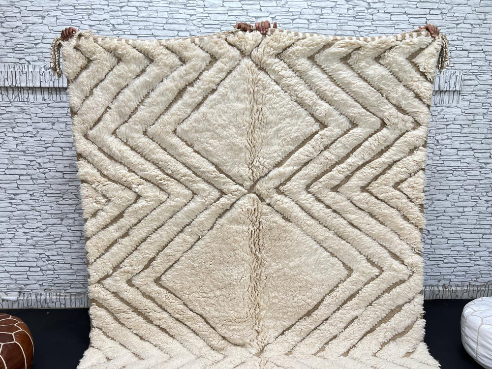 Handmade beige Moroccan wool rug with chevron geometric pattern, soft plush texture