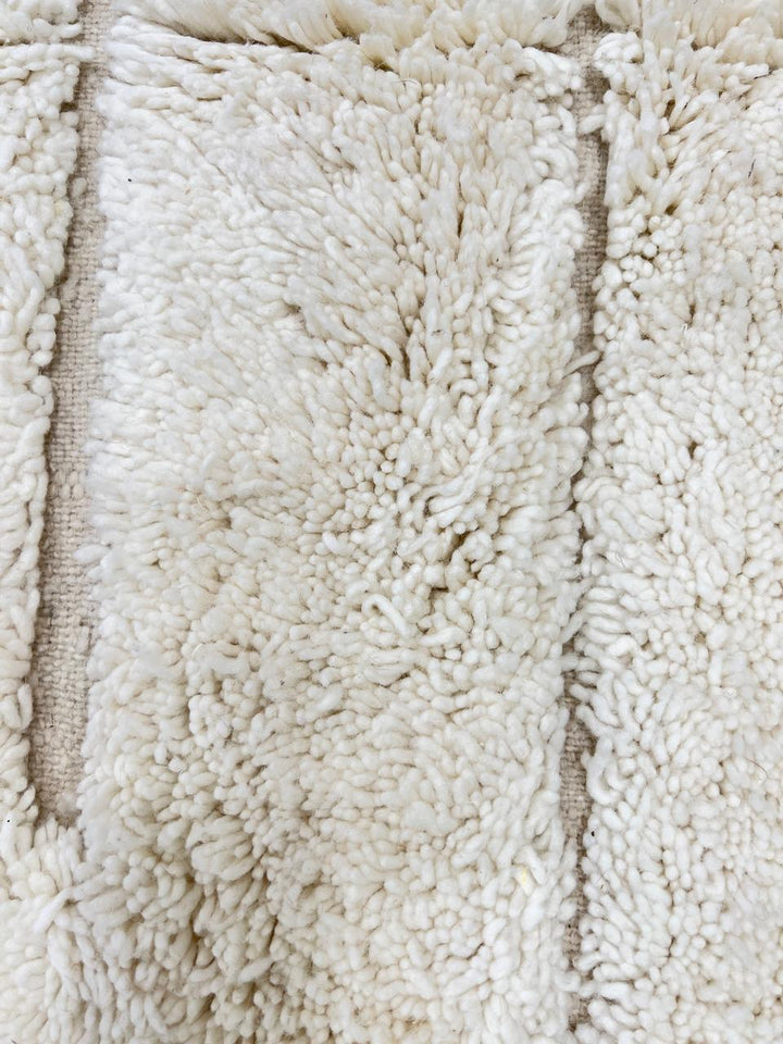 Handwoven beige Moroccan wool rug with shaved grid geometric pattern