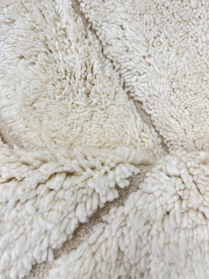 Handwoven beige Moroccan wool rug with shaved grid geometric pattern