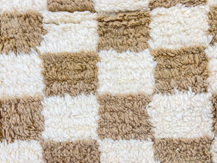 Handmade Moroccan runner rug with beige and white checkerboard pattern crafted from natural wool.