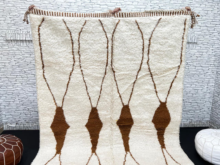 Beige and brown Moroccan wool rug with geometric design, handmade by Berber artisans using natural wool