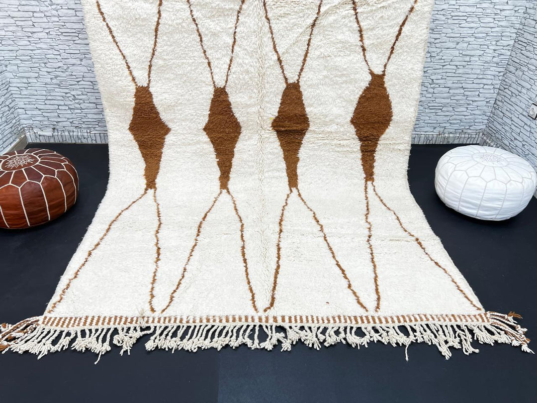 Beige and brown Moroccan wool rug with geometric design, handmade by Berber artisans using natural wool