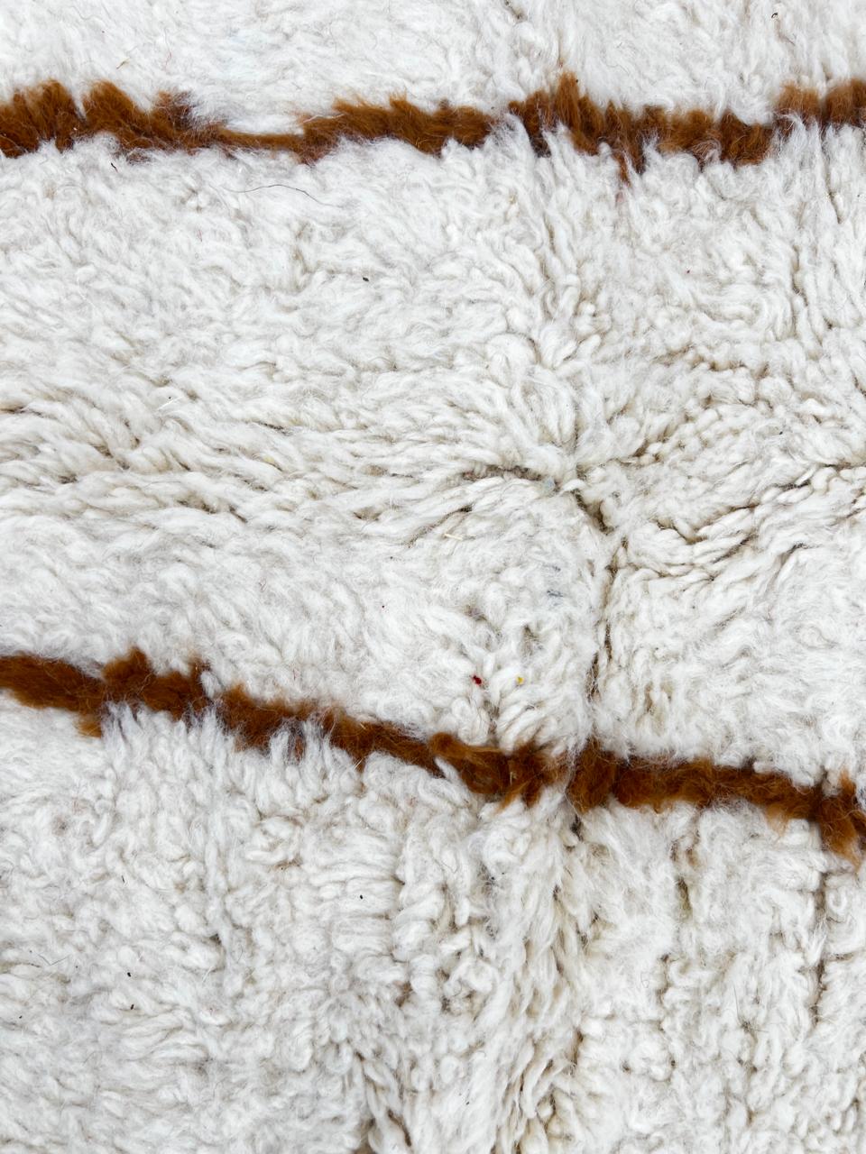 Beige and brown Moroccan wool rug with geometric design, handmade by Berber artisans using natural wool