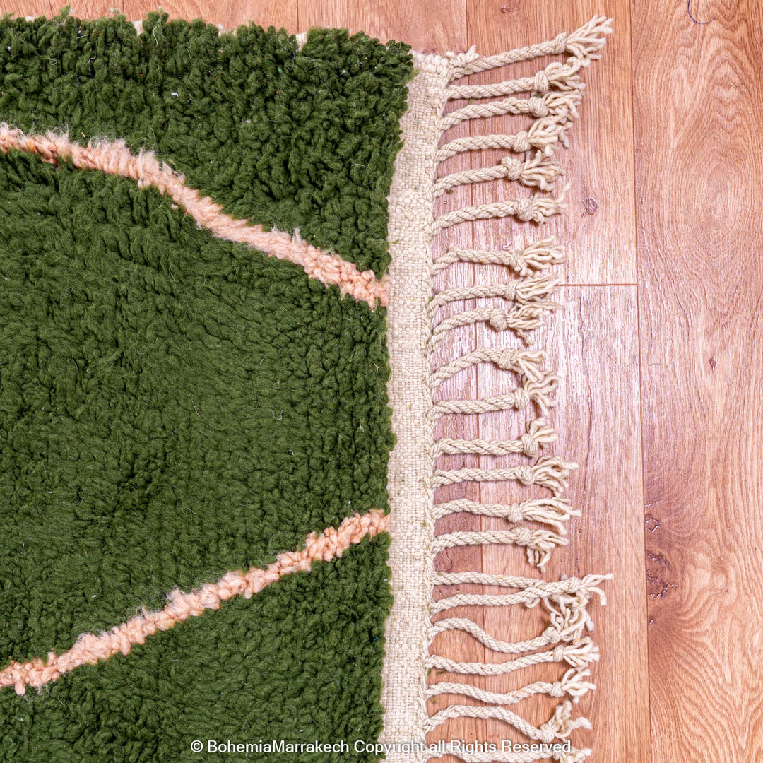 Green Moroccan rug with pink abstract desert motif design, handmade in wool