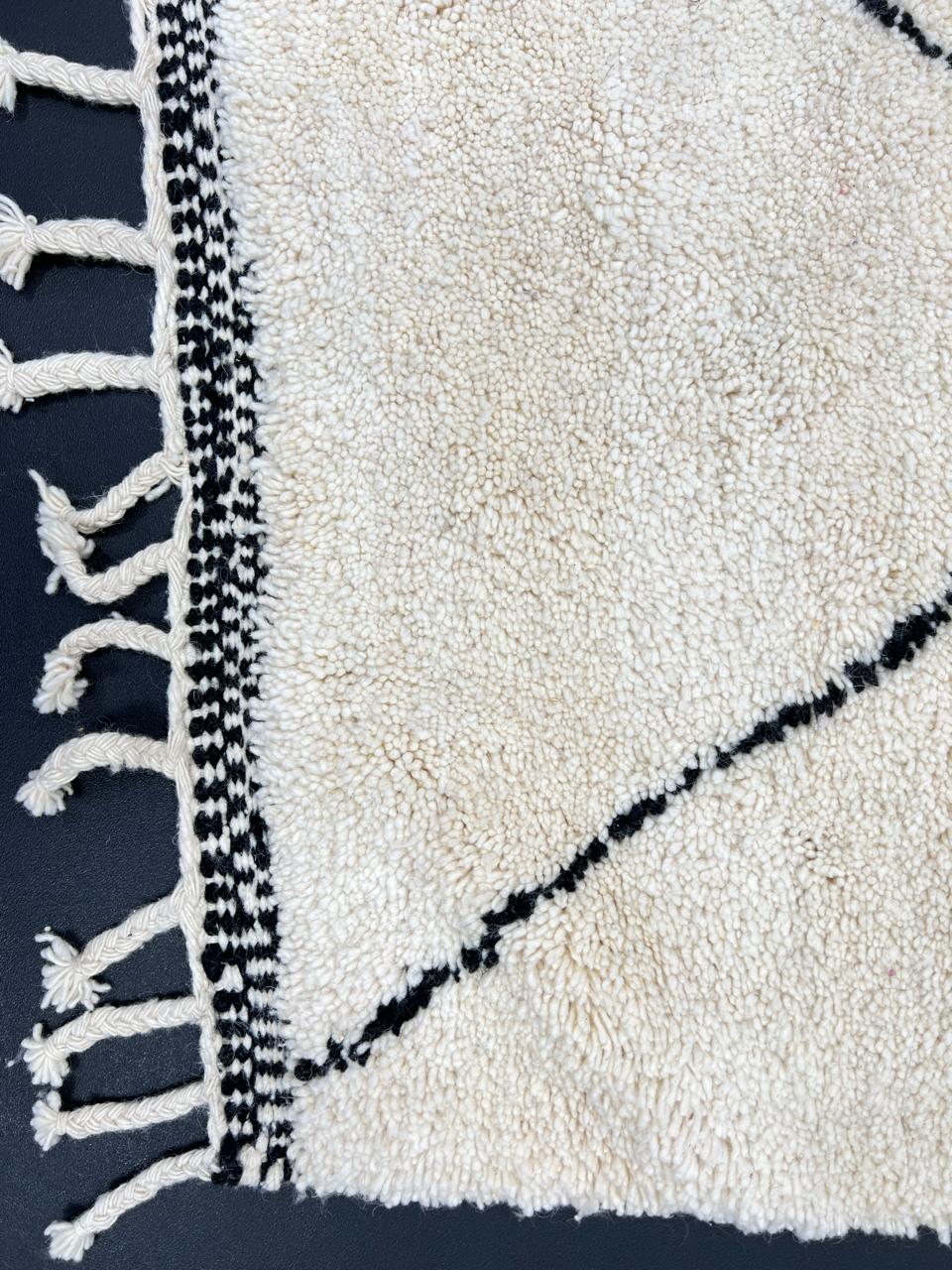 Black and white Beni Ourain Moroccan wool runner rug with diamond pattern and fringed edges
