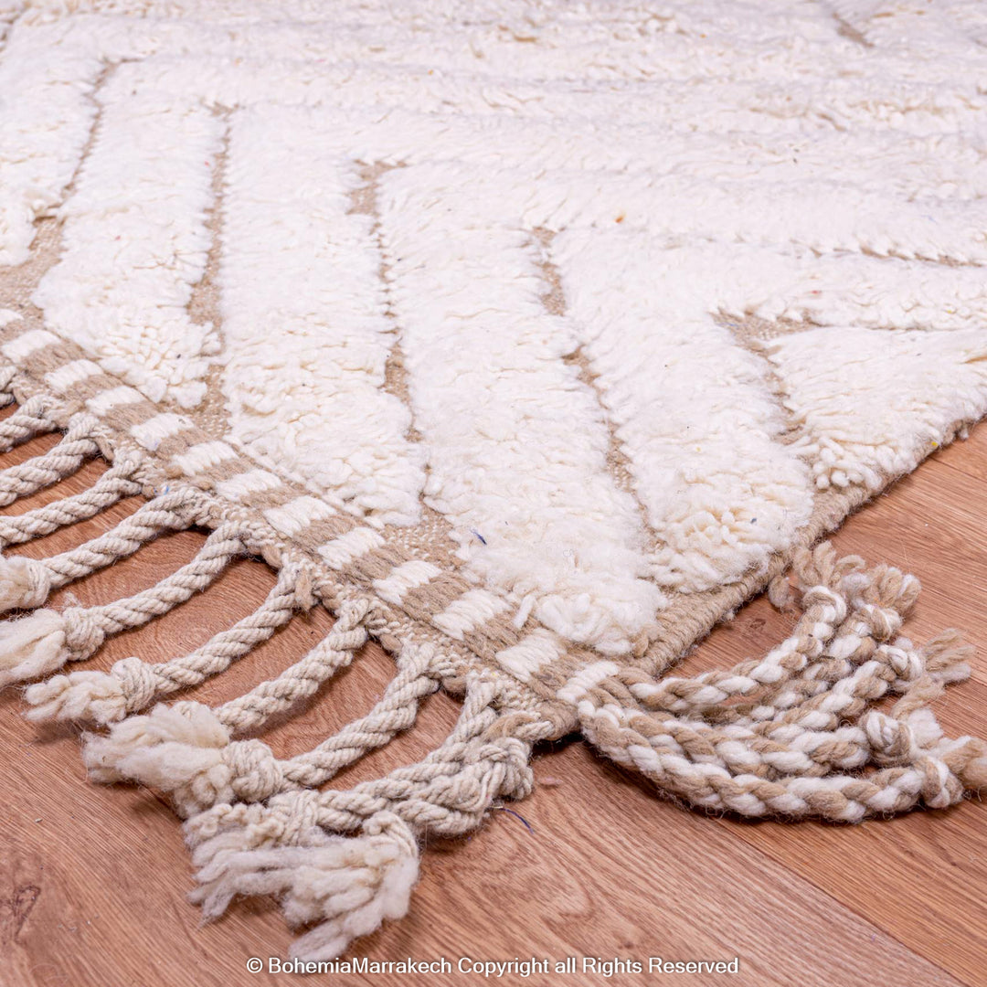 Handmade Beni Ourain Moroccan rug with geometric pattern and fringe, made from 100% natural wool. Perfect for a cozy, boho home.