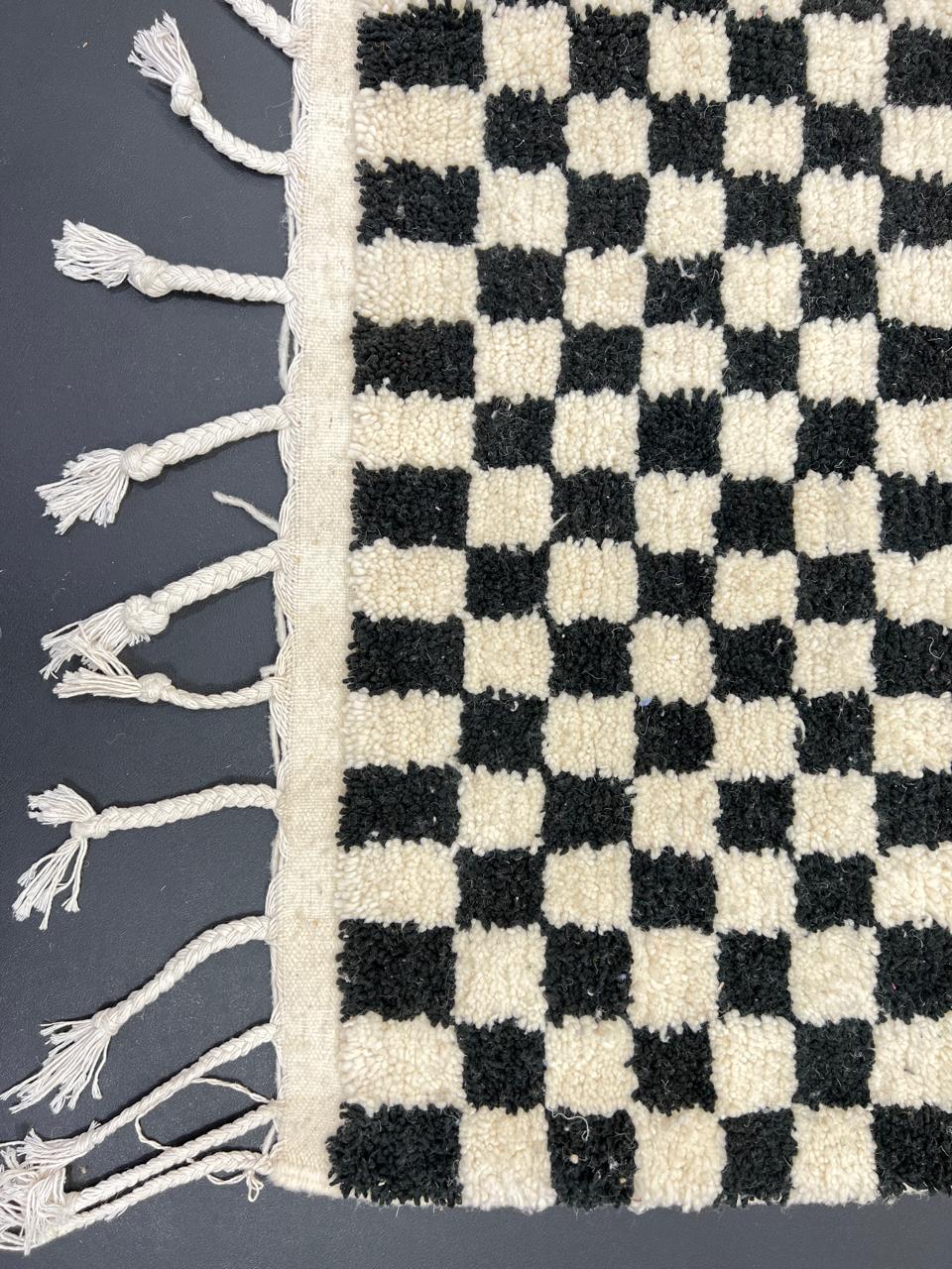 Handwoven black and white Moroccan wool rug with checkerboard pattern