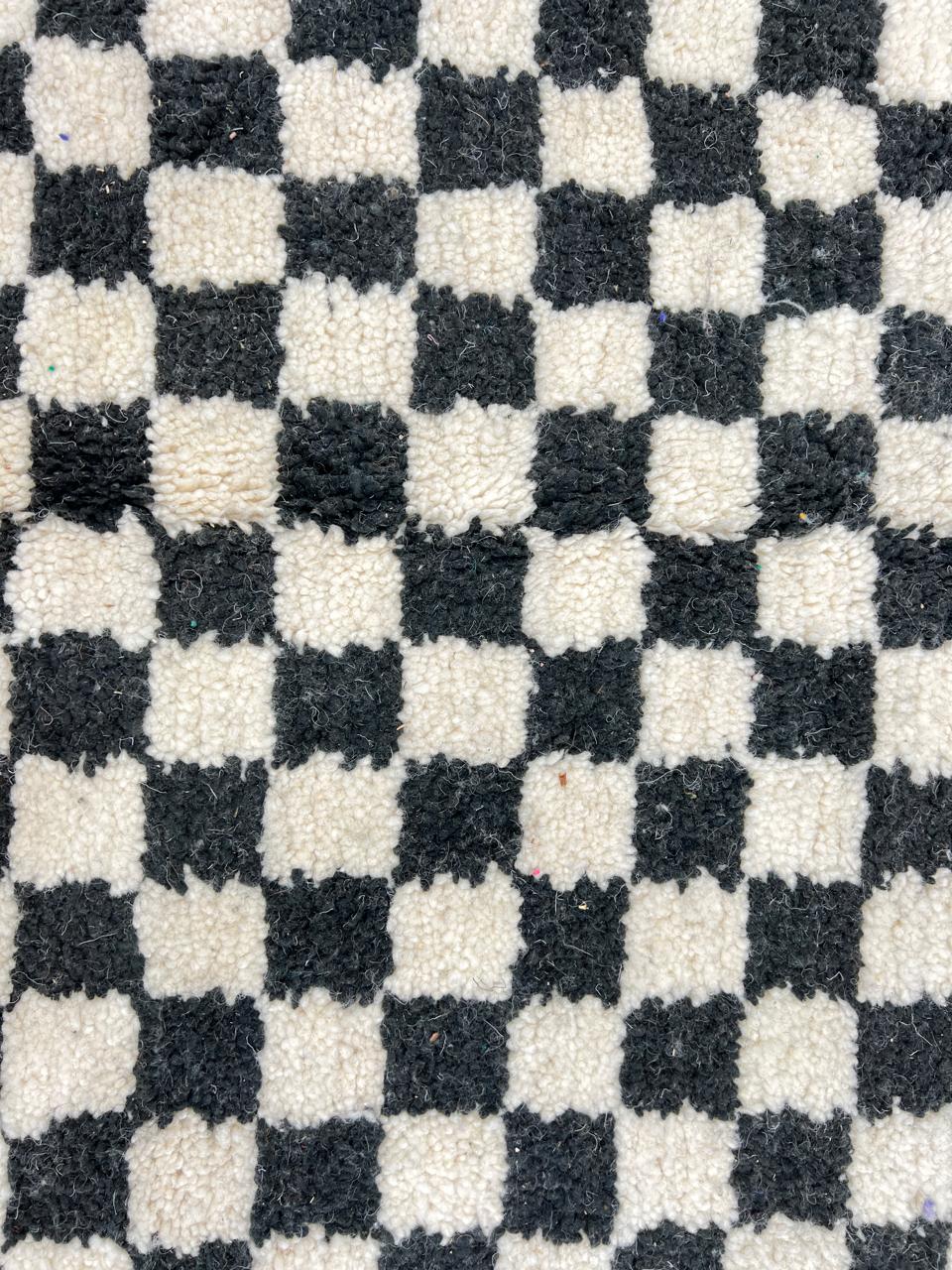 Handwoven black and white Moroccan wool rug with checkerboard pattern