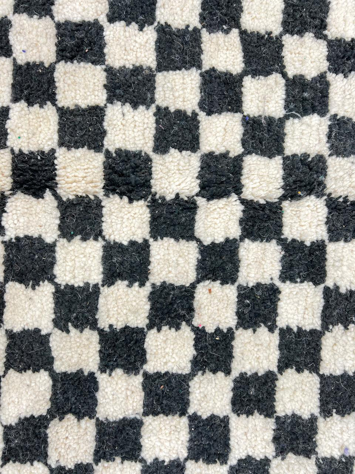 Handwoven black and white Moroccan wool rug with checkerboard pattern