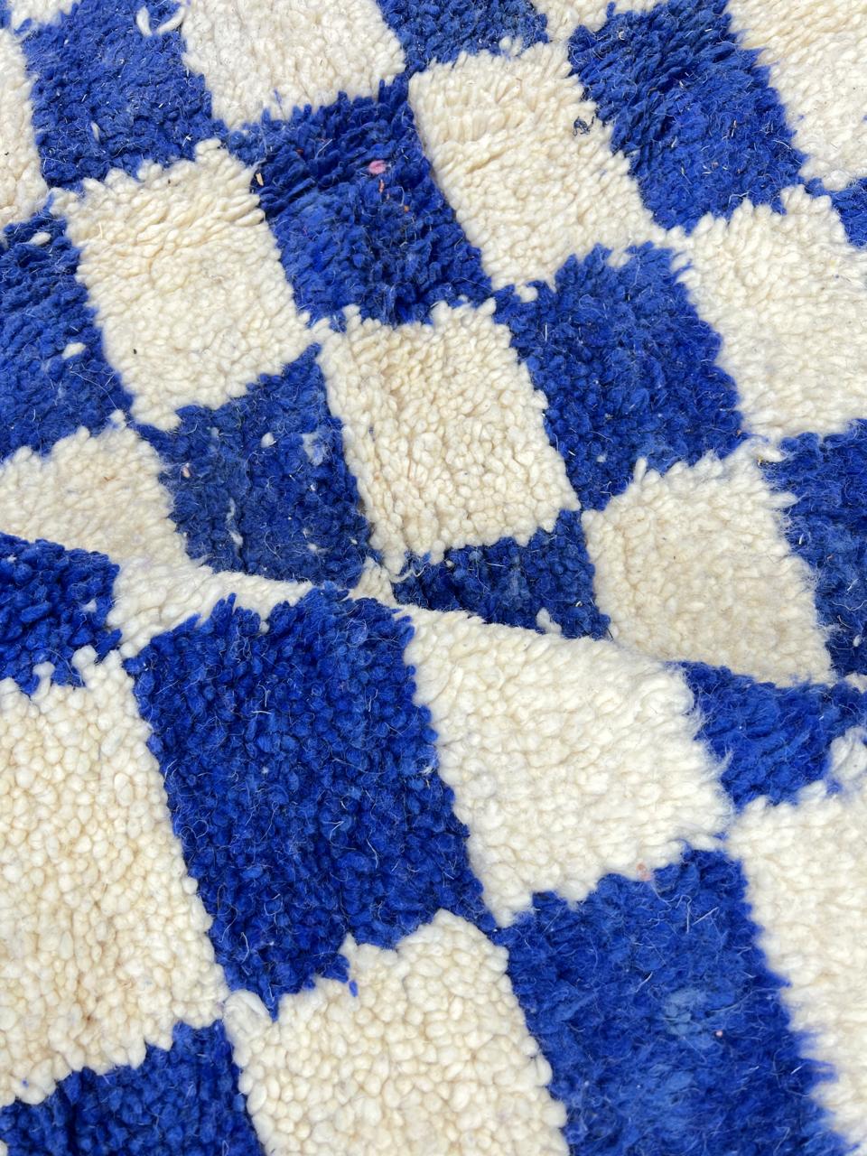 Blue and white checkered Moroccan round rug with modern geometric pattern.