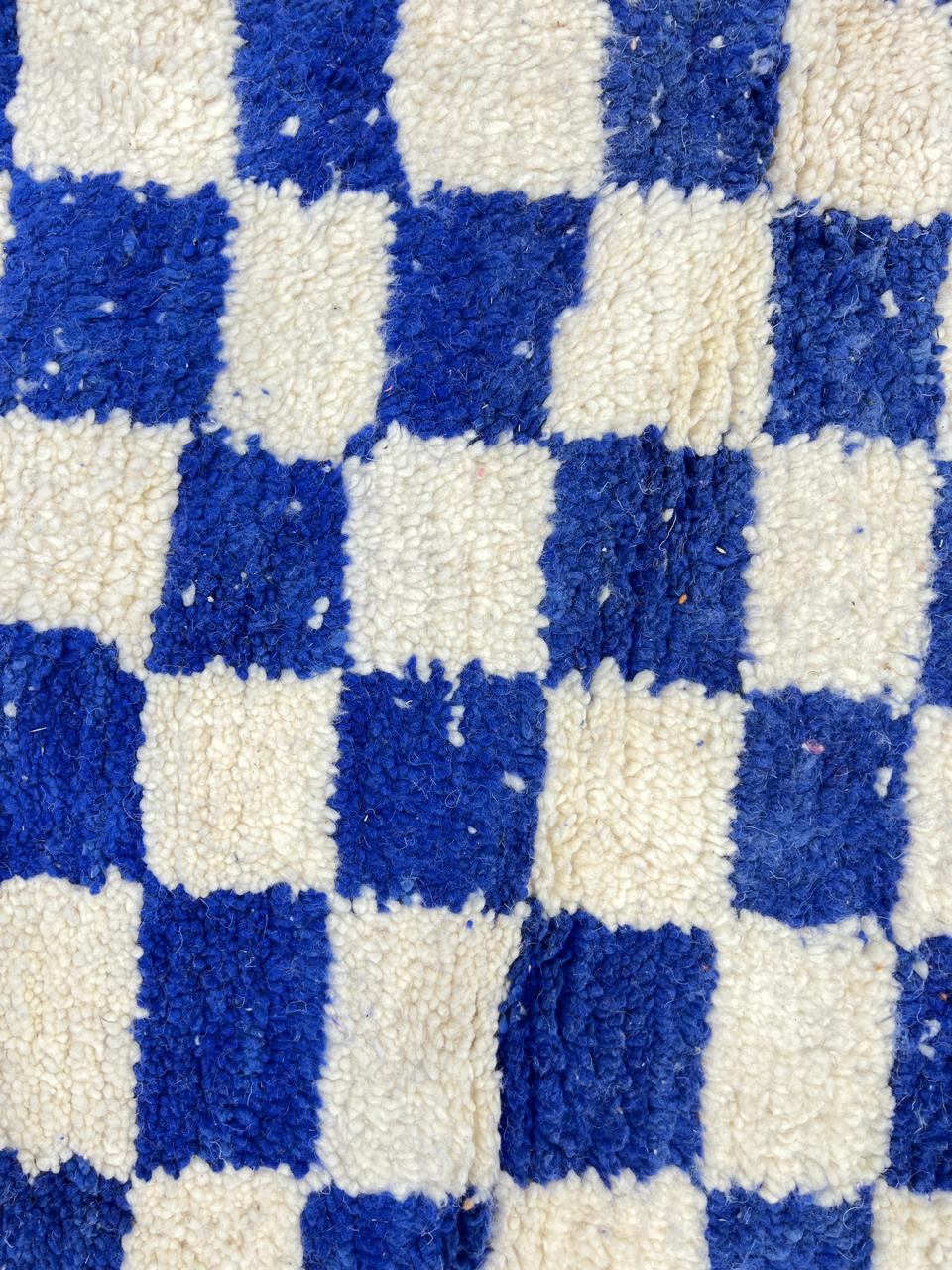 Handwoven Moroccan wool rug with blue and cream checkered design