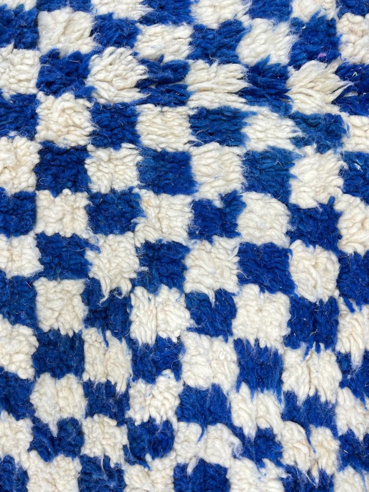 Handwoven blue and cream Moroccan wool rug with checkered design