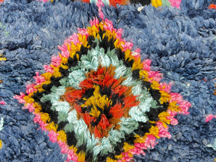 Handmade blue Moroccan runner rug with colorful Berber diamond motifs, crafted from natural wool in a traditional geometric design.