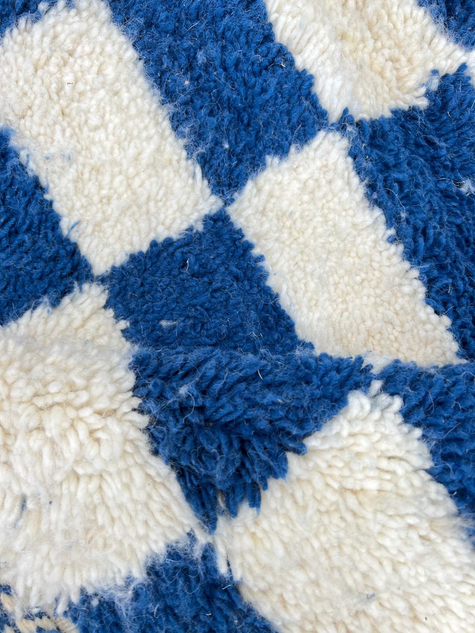 Handwoven blue and white Moroccan wool rug with checkerboard pattern