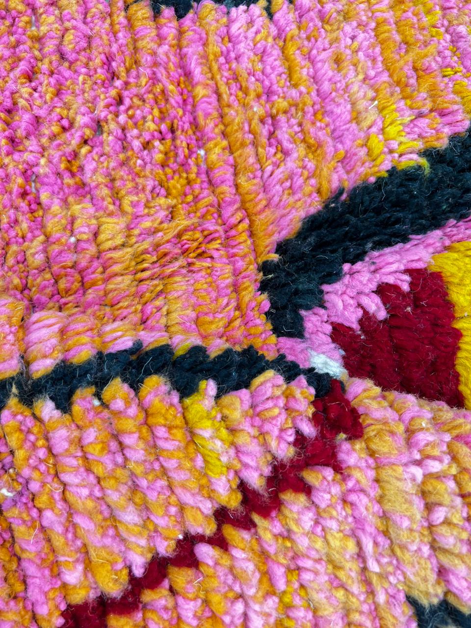 Colorful Moroccan wool rug handmade with coral pink, green, and mustard geometric patterns