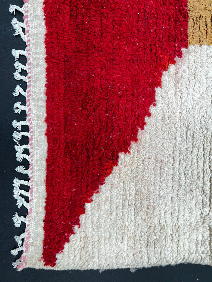 Colorful abstract Moroccan runner rug with artistic face design, handmade wool carpet featuring turquoise, yellow, red and purple shapes on a soft white background, modern boho Moroccan wool runner for hallway decor.