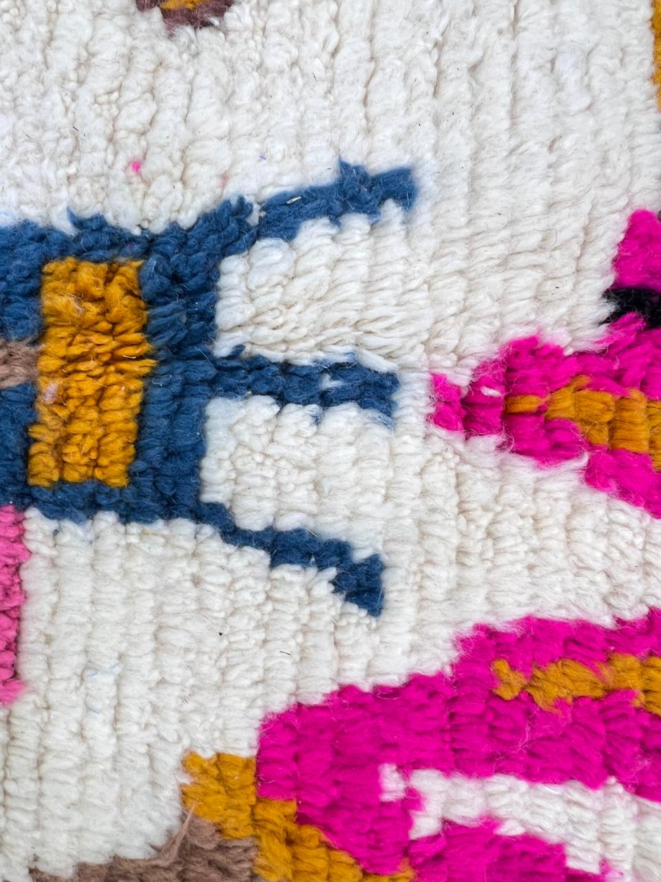 Colorful Berber Moroccan runner rug handmade from white wool with abstract symbols