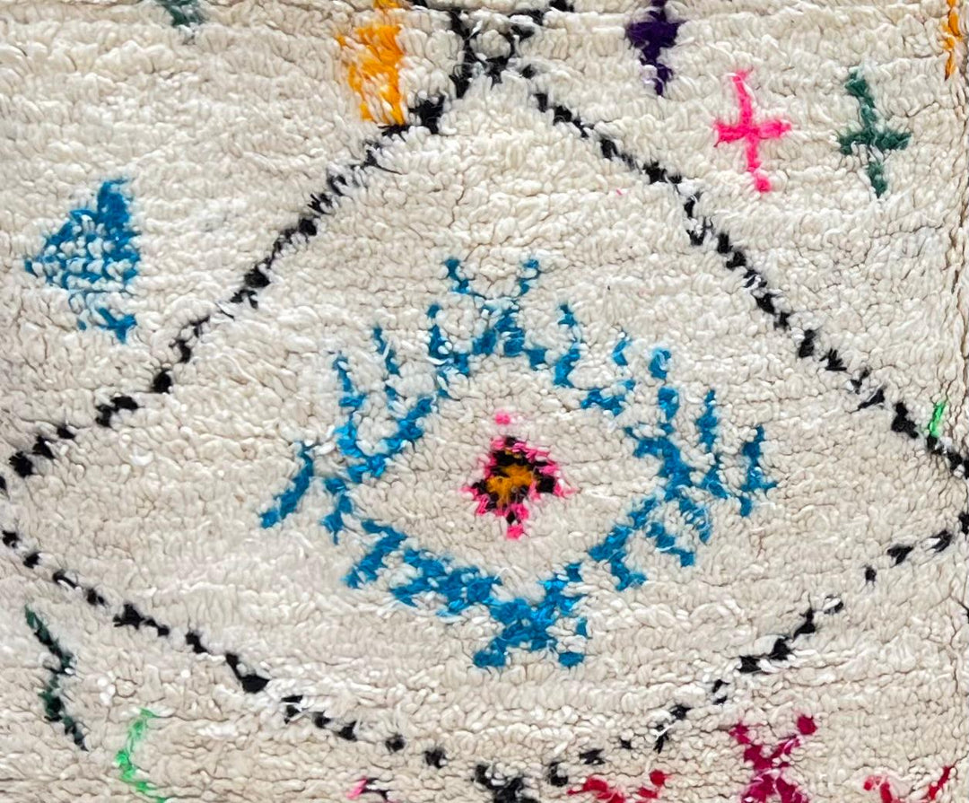 Handmade ivory Moroccan wool runner rug with colorful Berber motifs inside black diamond Beni Ourain pattern