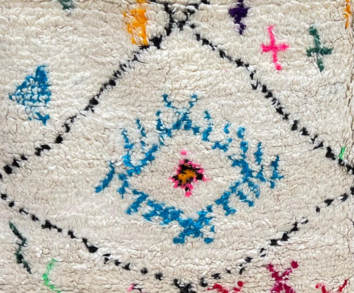 Handmade ivory Moroccan wool runner rug with colorful Berber motifs inside black diamond Beni Ourain pattern