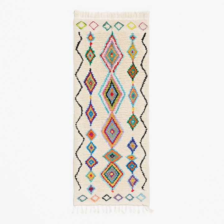 Colorful handmade Moroccan wool runner rug with multicolor diamond patterns on white background