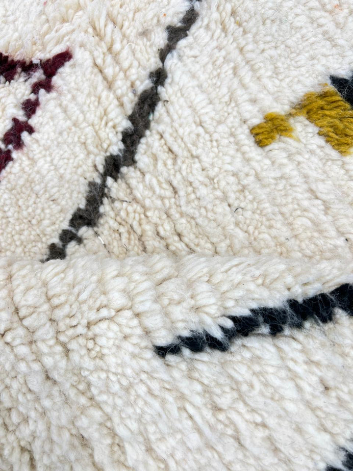 Handwoven Moroccan wool rug with multicolor geometric motifs on an ivory background, colorful Berber rug