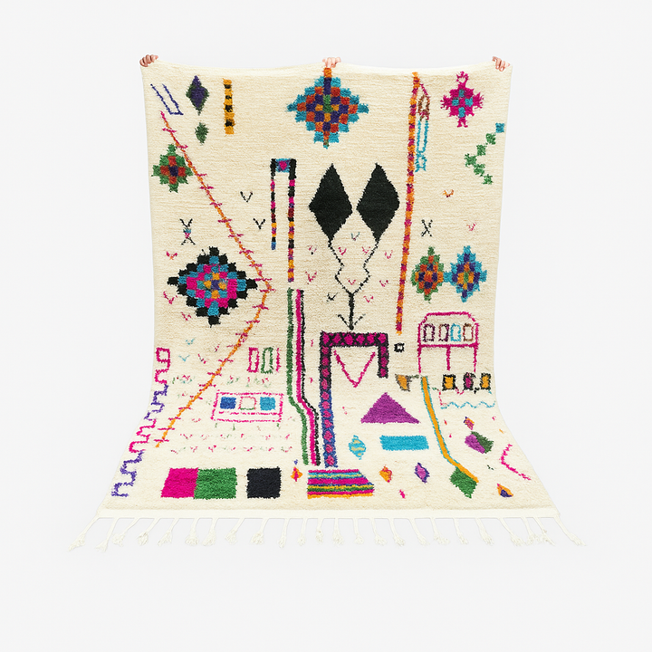 Handwoven colorful Moroccan wool rug with geometric Berber motifs on ivory background