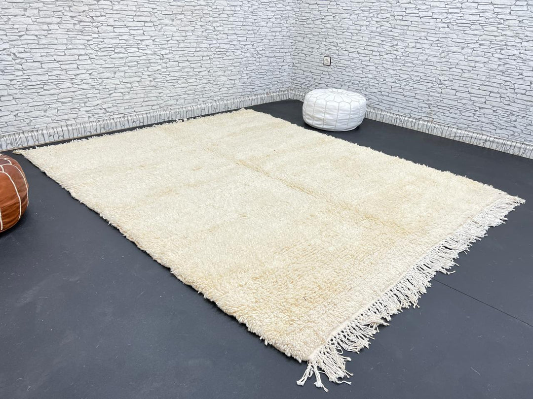 Cream handmade Moroccan wool rug with soft plush texture and fringed edges