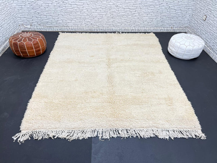 Cream handmade Moroccan wool rug with soft plush texture and fringed edges