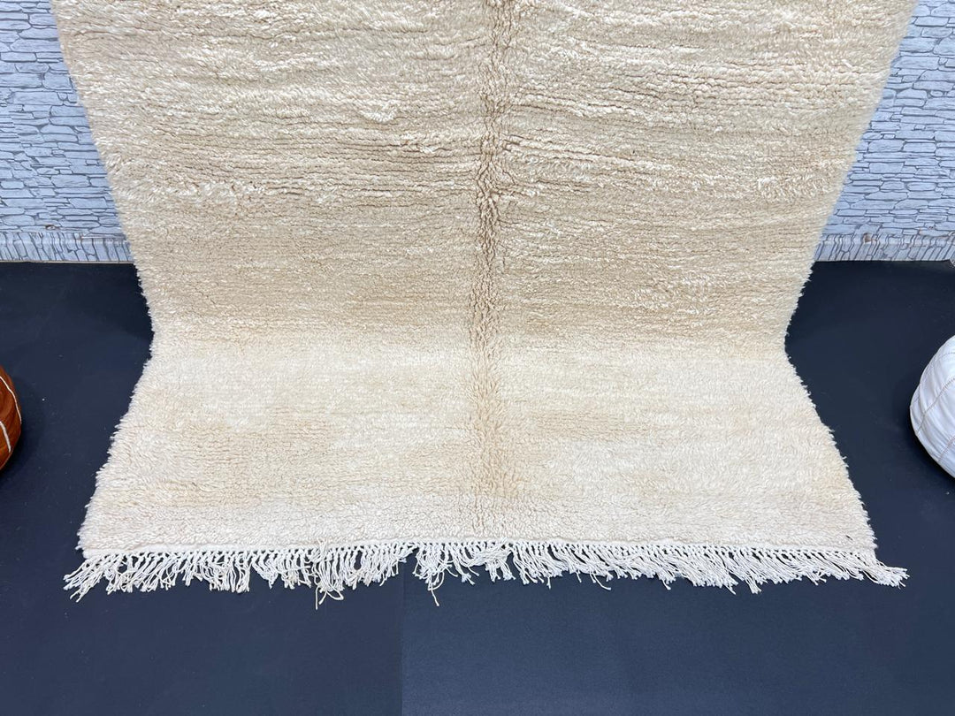 Cream handmade Moroccan wool rug with soft plush texture and fringed edges