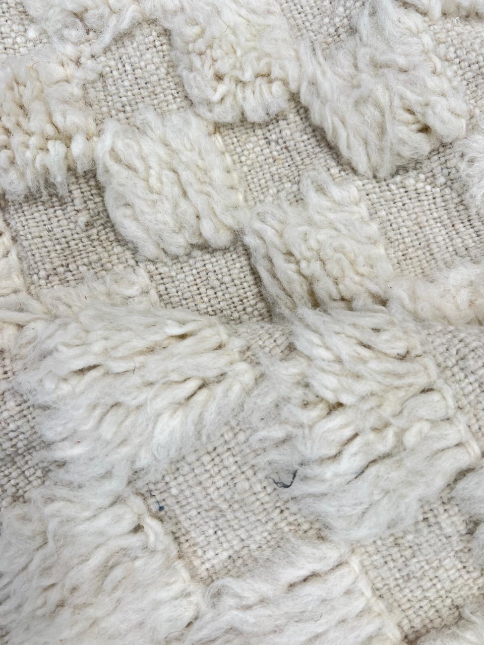Cream textured Moroccan wool rug with raised dot design