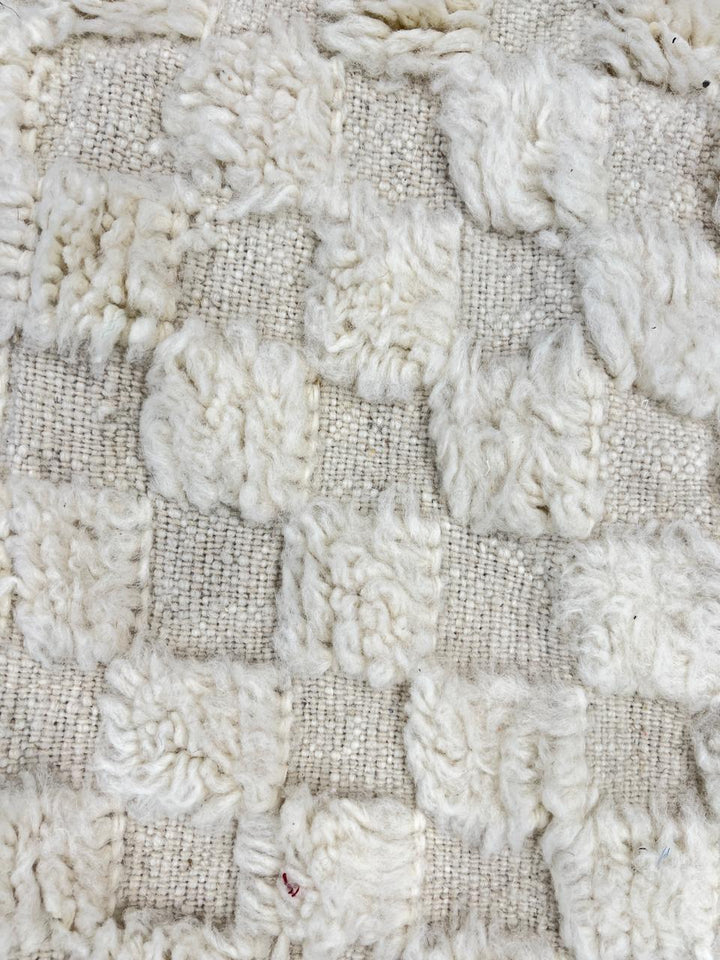 Cream textured Moroccan wool rug with raised dot design