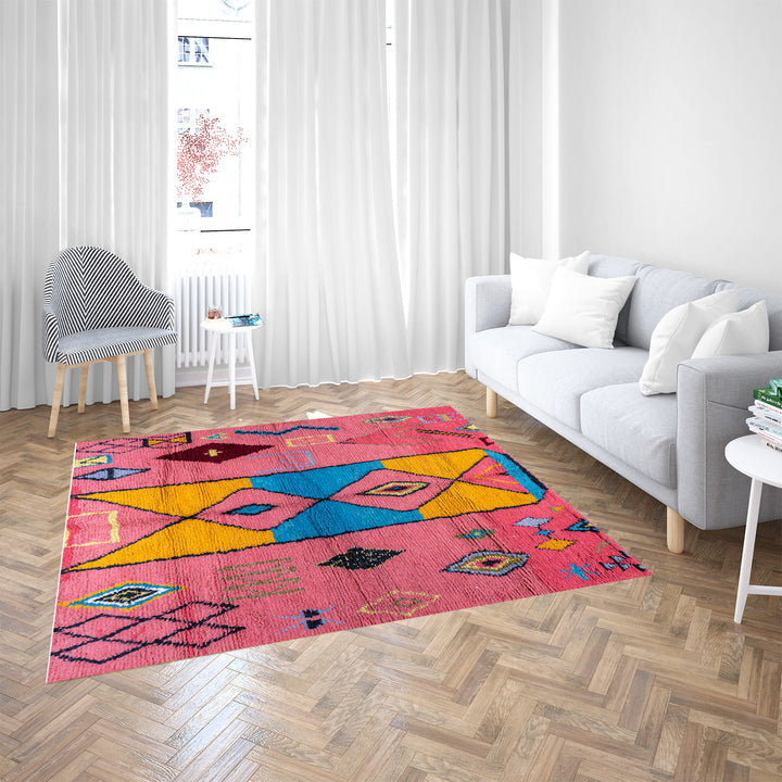 Colorful bright pink Moroccan wool rug with blue and yellow diamond patterns