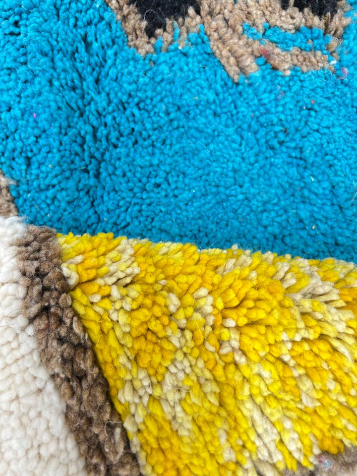 Colorful geometric Moroccan wool runner rug with red, green, yellow, blue, and cream abstract pattern