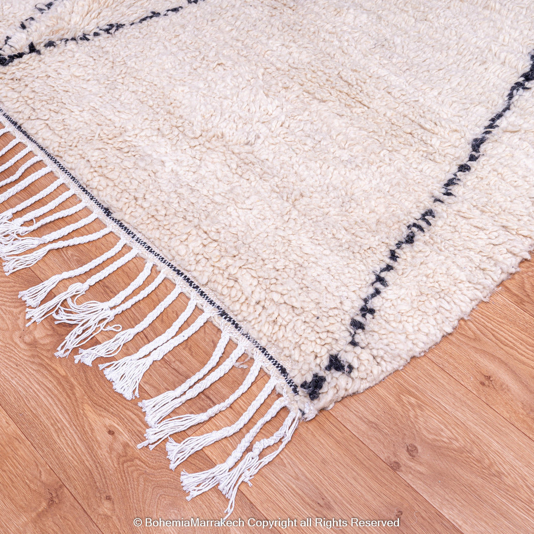Handmade Beni Ourain Moroccan wool rug with black diamond design on cream background