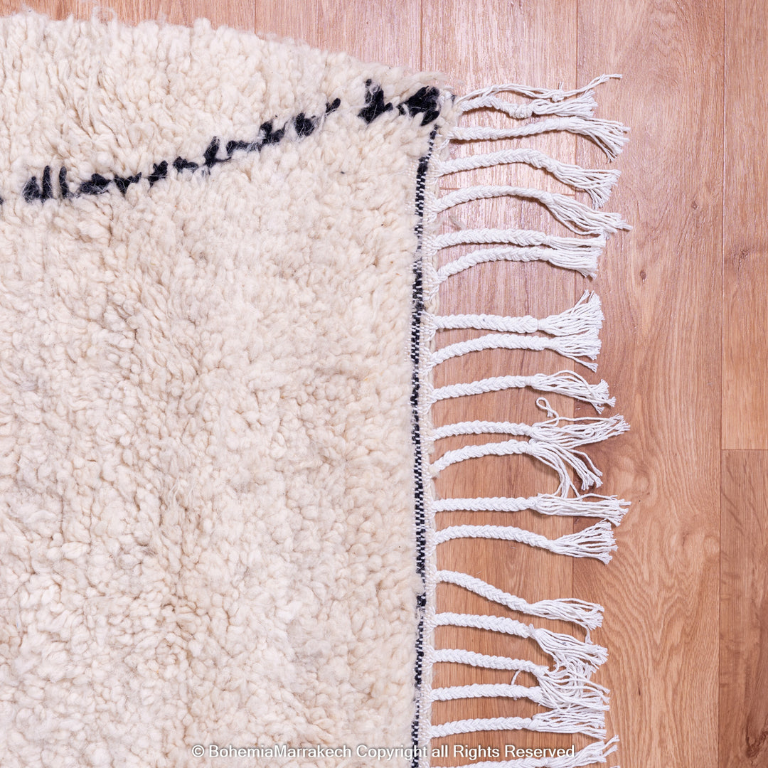 Handmade Beni Ourain Moroccan wool rug with black diamond design on cream background