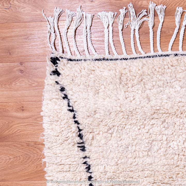 Handmade Beni Ourain Moroccan wool rug with black diamond design on cream background