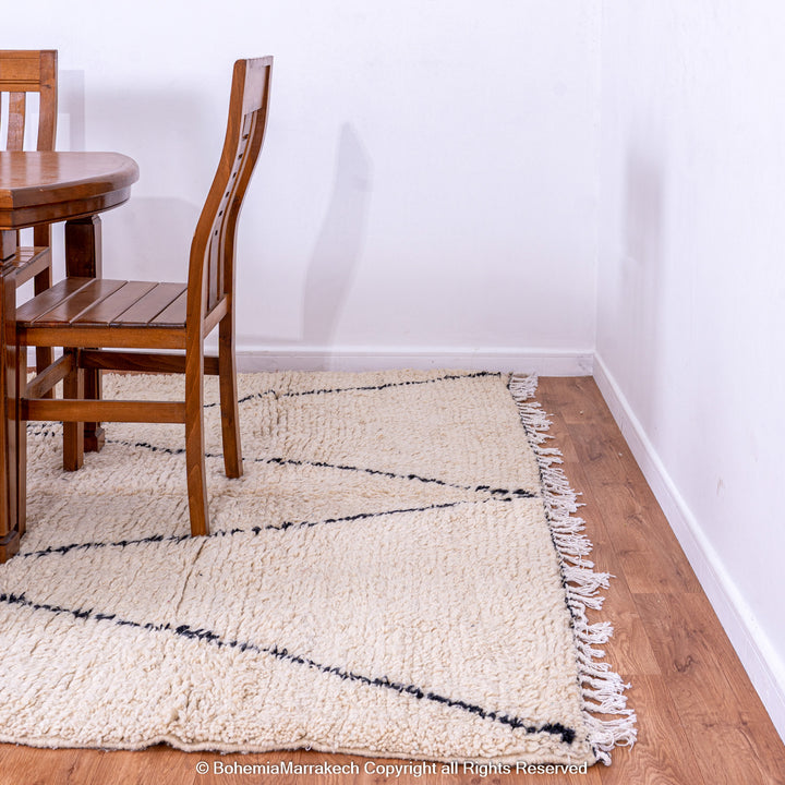 Handmade Beni Ourain Moroccan wool rug with black diamond design on cream background