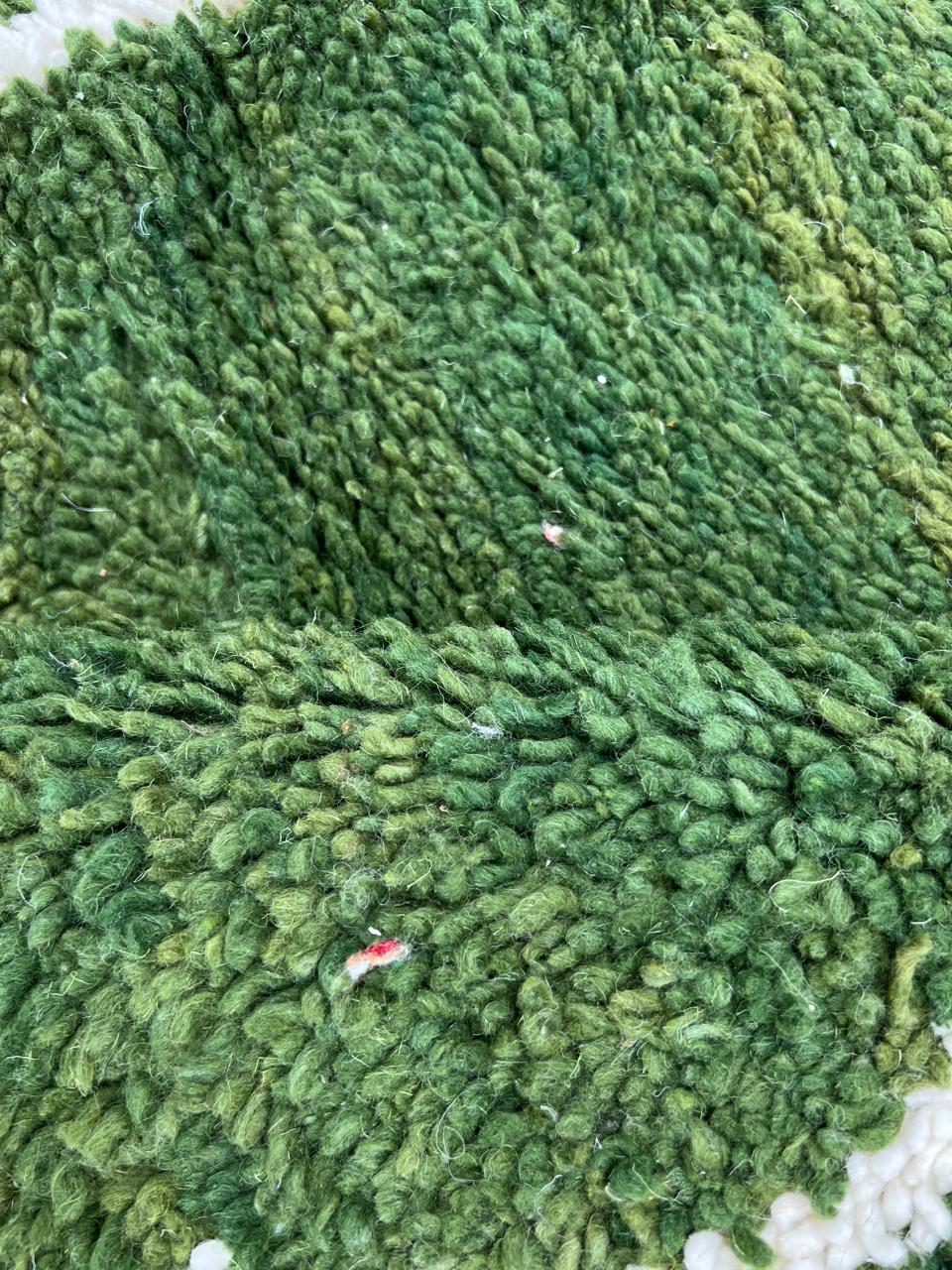 Handmade green Moroccan runner rug with white abstract linear design on natural wool.