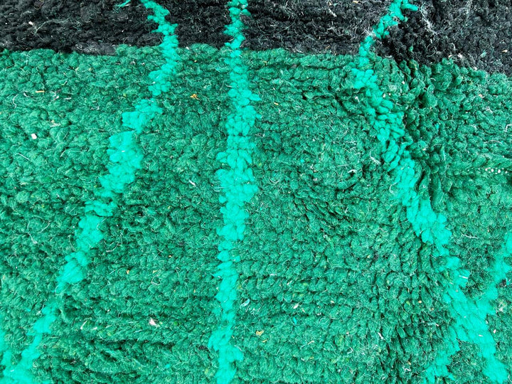 Handwoven green Moroccan wool runner rug with geometric line patterns and black gradient base.