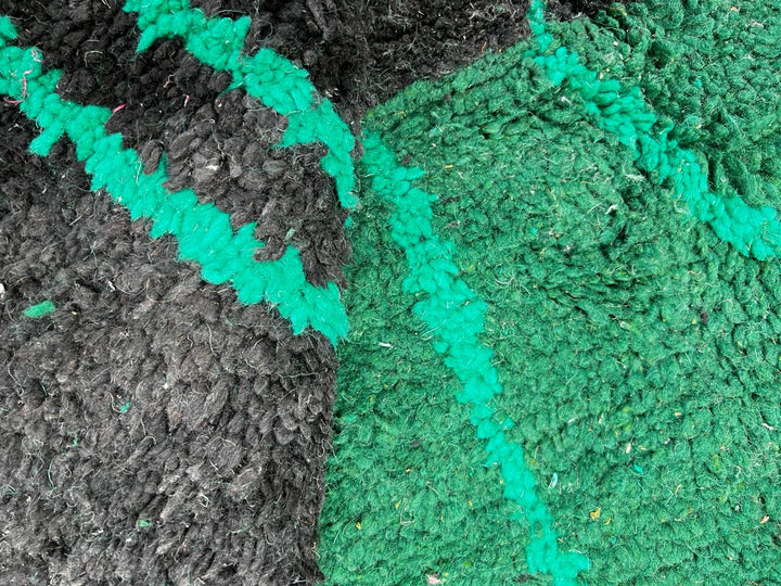 Handwoven green Moroccan wool runner rug with geometric line patterns and black gradient base.