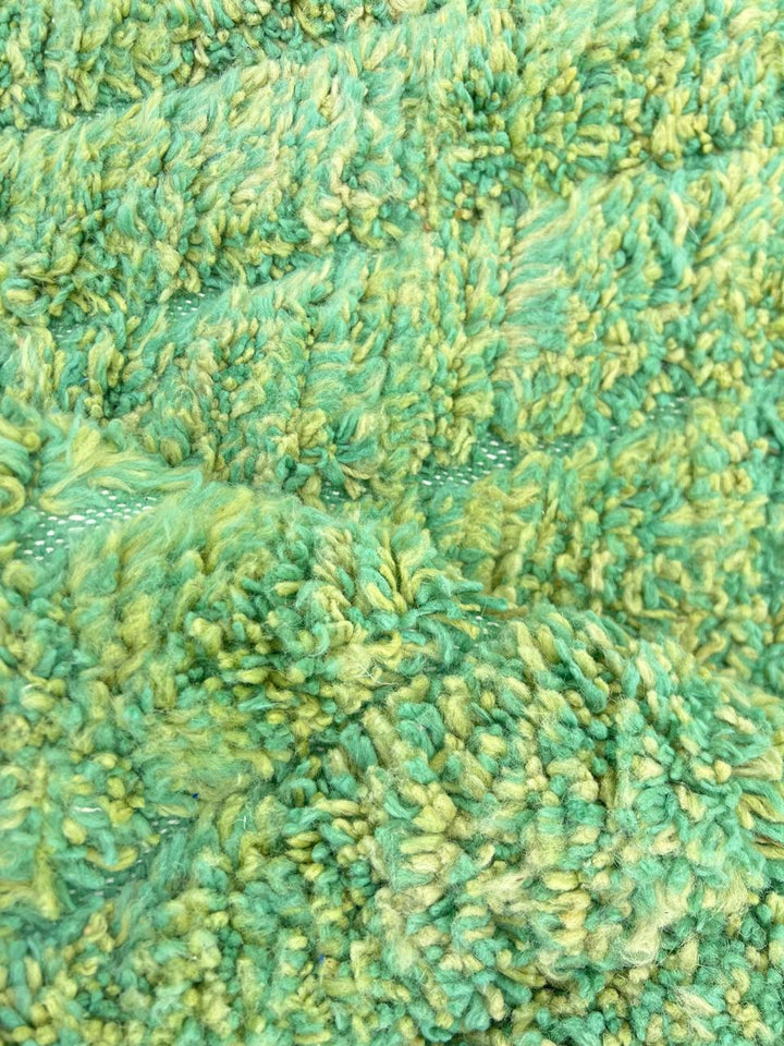 Green Moroccan wool rug with carved geometric lines and sculpted texture