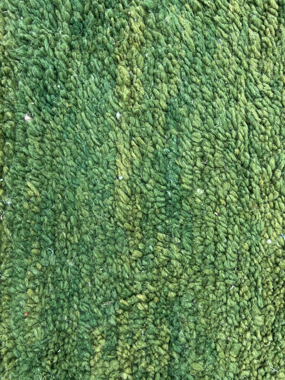 Green Moroccan round rug with white Berber line pattern, handmade wool.