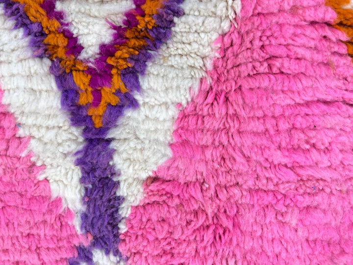 Colorful round Moroccan wool rug with ivory base, bold Berber diamond motifs, and handmade plush wool texture.